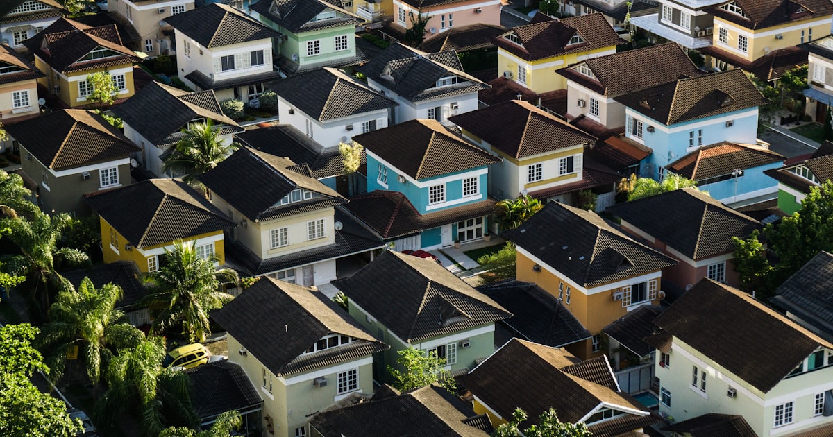 Aerial view of a suburban neighborhood — insurance costs vary dramatically by ZIP code